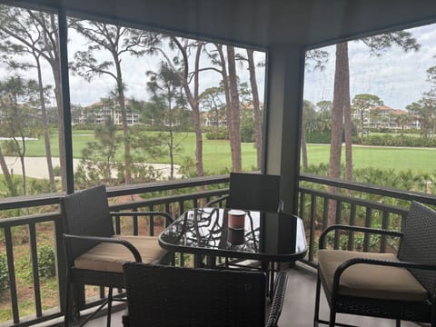 Peaceful place for a coffee or cocktail at high table on screened lanai.