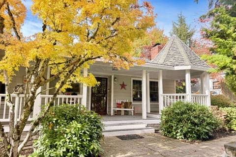 Charming home surrounded by trees with a covered front porch and gazebo. Enjoy a cozy, nature-filled atmosphere perfect for families and pet-friendly stays.