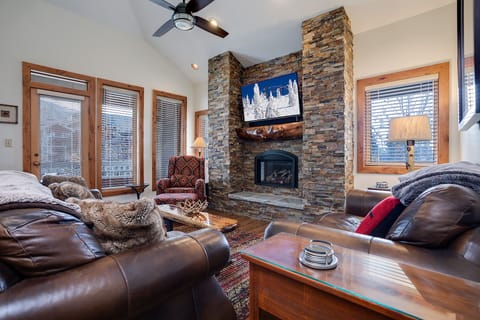 Sink into plush leather sofas beside your crackling stone fireplace while mountain adventures play on the flatscreen TV above.