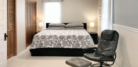 King size bed with memory foam mattress in primary bedroom located upstairs.