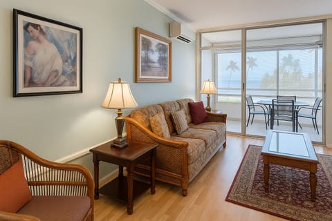 Relax in your bright living room with tropical breezes, ocean views through sliding glass doors, and your own private balcony for morning coffee or evening unwinding.