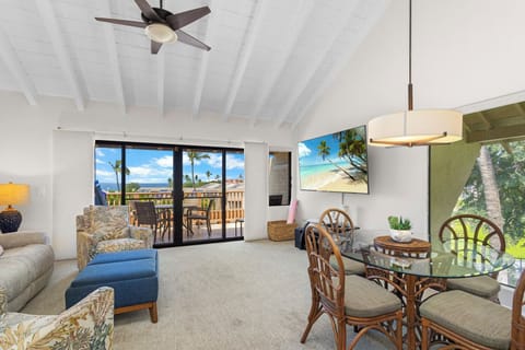 Unwind in your tropical island retreat, where soaring wood-beam ceilings and island breezes greet you, with ocean views and swaying palms framing your perfect getaway.