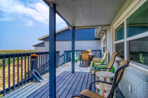 Step onto your private deck where comfortable chairs invite morning coffee moments while overlooking serene coastal views.