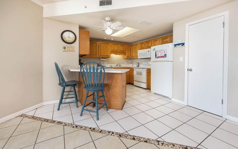 Gather around the breakfast bar, perfect for coffee or casual meals in this inviting kitchen space