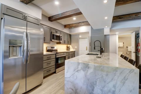 Modern kitchen with stainless steel appliances.