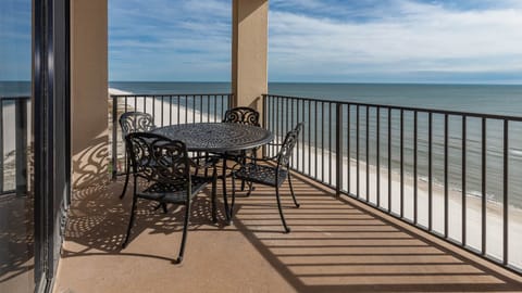 Dine al fresco at the round table, taking in the expansive views of the tranquil waters and shoreline