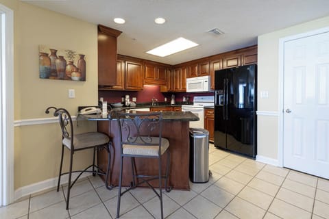 Gather around the stylish bar seating in this elegant kitchen, perfect for casual meals or morning coffee
