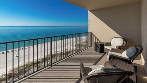 Enjoy the fresh air from the balcony with comfortable seating and a view of the tranquil waters below