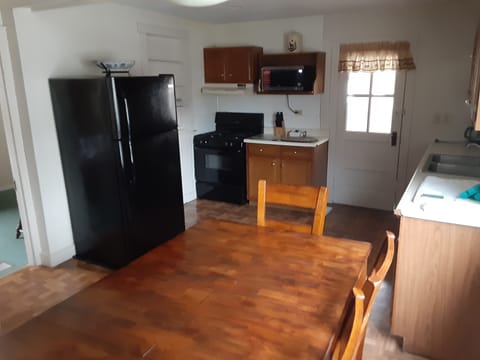 refrigerator with gas stove and microwave all cooking pots and pans  many dishes