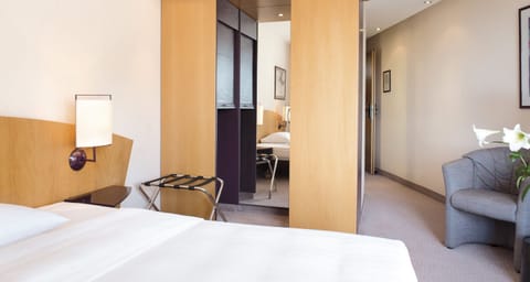 Hypo-allergenic bedding, desk, laptop workspace, blackout drapes