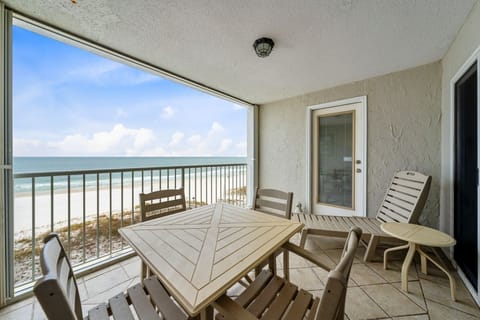 Your private beachfront balcony awaits with stunning sea views and space to dine while listening to gentle waves below.