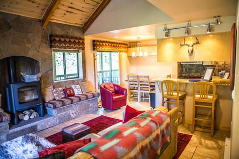 The main living area has a sofa, chair, and fireplace seating with a Smart TV!