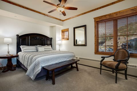 Sink into crisp linens and drift off under the gentle breeze of your ceiling fan, while warm wood accents and soft lighting wrap you in comfort.
