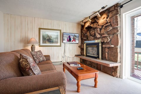Cozy up by your stone fireplace with plush seating and mountain charm for perfect evenings in.
