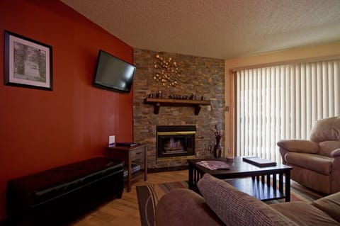 Relax in your cozy living room with a warm stone fireplace, plush seating, and all the comforts of home.