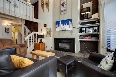 Cozy up by your fireplace in this inviting living room, where mountain decor and comfortable seating create the perfect retreat.
