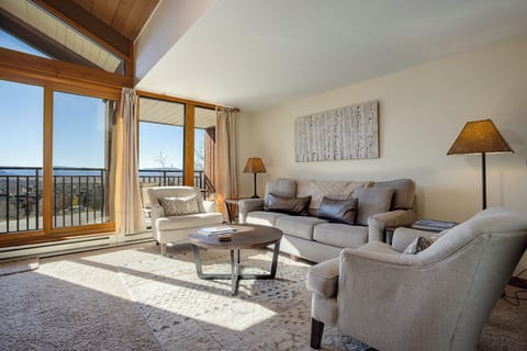 Settle into this bright living room where natural light streams through floor-to-ceiling windows, creating the perfect spot for your morning coffee.