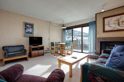 Relax in your cozy living space with mountain views, fireplace warmth, and comfortable seating perfect for après-ski evenings.
