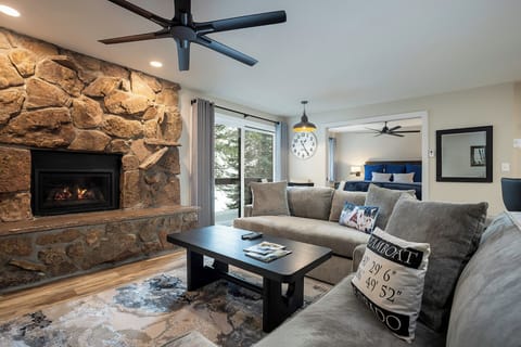 Curl up on this plush sofa by your crackling stone fireplace, where mountain comfort meets modern style in your perfect retreat.