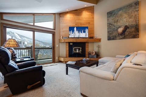 Curl up by your private fireplace while soaking in stunning mountain views through floor-to-ceiling windows.