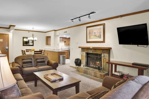 Park Station 214 has an open floor plan living room with comfortable couches and a real wood burning fireplace.
