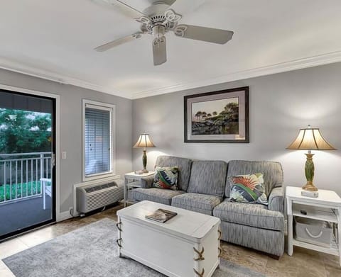 Ocean Dunes 102 - Living Room - New travertine flooring, along with new queen sized sofa bed and easy access to the balcony that seats 4.