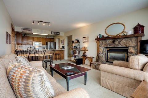 Cozy up by your stone fireplace while enjoying the open living space that flows seamlessly into your fully-equipped kitchen.
