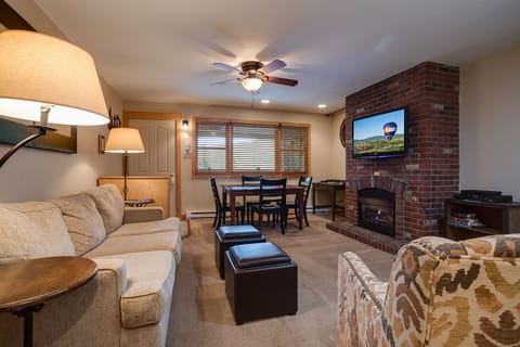 Unwind in your cozy living room, complete with fireplace warmth, comfortable seating, and entertainment for perfect evenings in.