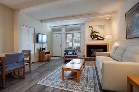 Unwind in your cozy living space featuring a warm fireplace, comfortable seating, and modern amenities for the perfect mountain retreat.