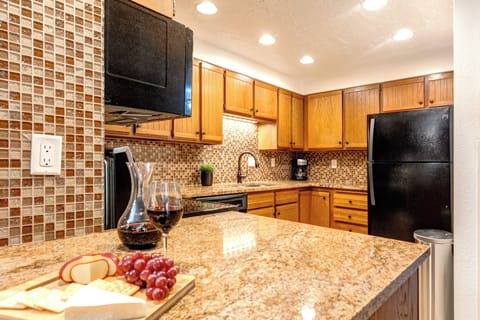 Park Station 124 has a well equipped kitchen with black appliances and wood cabinets.