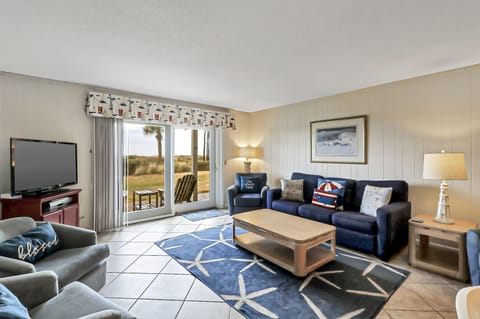 Living area - Spacious living room and large flat screen TV and new flooring.  Easy access onto back patio.