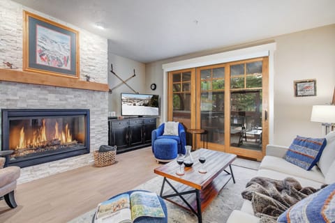 Curl up by the cozy fireplace, sip your favorite drink, and unwind in this beautifully designed living room. Doors open to your private balcony for mountain fresh air.
