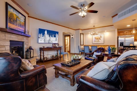 Sink into plush leather seating by the stone fireplace, where mountain views and warm wood accents create your perfect alpine retreat.