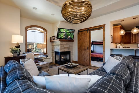 Cozy up by your private fireplace in this stylish living space, where rustic charm meets modern comfort for perfect mountain retreat evenings.
