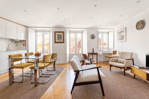 A stylish, spacious and bright lounge with open kitchen and two small balconies