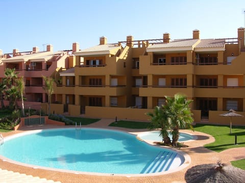 Large swimming pool with beautiful landscaped gardens around it.