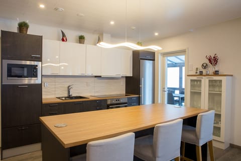 open concept living room kitchen dining area with fireplace and lake view