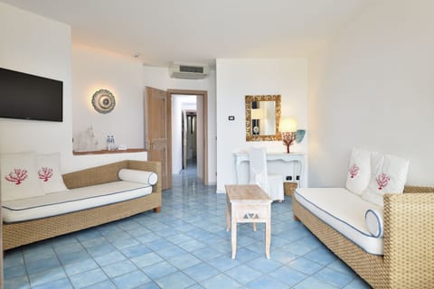 Family Suite for 2 adults and 2 children | Living area | 22-inch flat-screen TV with satellite channels, TV, books