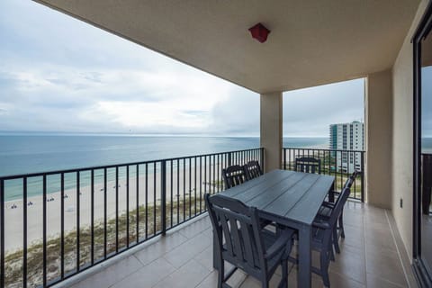 Dine al fresco at the spacious table on the balcony, enjoying refreshing views of the tranquil waters and beach