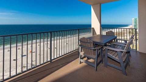Enjoy meals at the outdoor table, soaking in views of the beach and gentle waves from your beachfront balcony