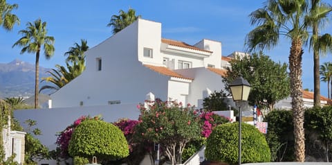 Front showing upstairs patio doors to balcony