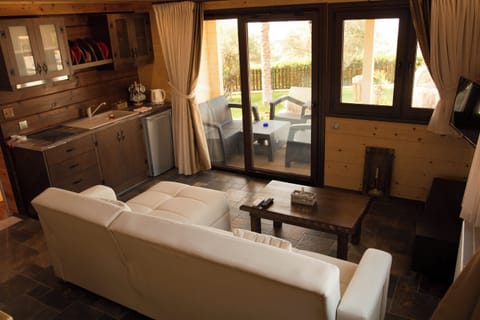 The Stonewood Cottage - 2 Bedroom Poolfront Villa with Sea View, Sauna & Shared Pool | Living room | Flat-screen TV