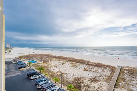 This inviting balcony offers a stunning beachfront view, perfect for relaxation and enjoying the serene atmosphere