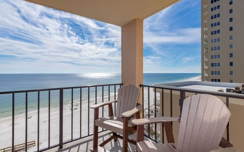Relax on the balcony's Adirondack chairs while enjoying the breathtaking beach view and tranquil blue waters