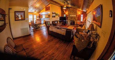 Living room with wood or electric fireplace viewed fr entryway. (wideangle lens)