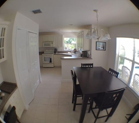 kitchen area with table that can easily seat 6 persons