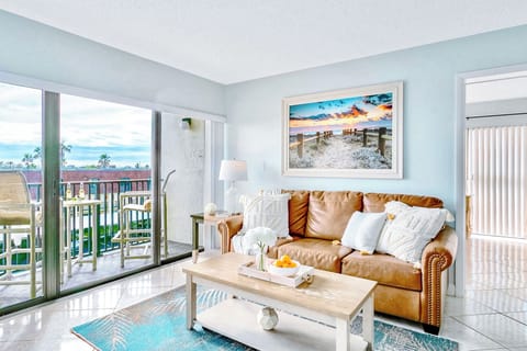 Cozy living area with a soft couch natural light and a relaxing beach vibe