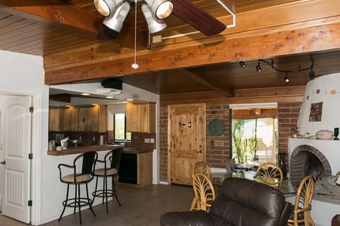 Living room showing kitchen, entrance door.