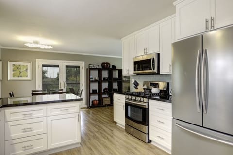 Bask in an abundance of natural light streaming through double glass doors leading to the backyard patio. The well-equipped kitchen ensures a delightful extended stay at your home away from home.