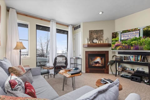 The Mason at Stillwater 2013: Cozy ambiance with a fireplace, perfect for relaxing by the window.